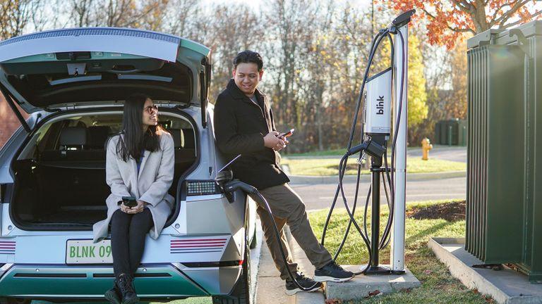 Couple charging their EV